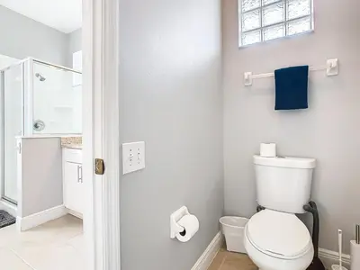 a white bathroom with a toilet and a shower at T8134-Windsor Palms Resort Pool and Spa Near Disney in Kissimmee