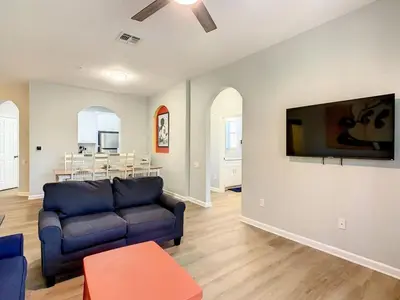 a living room with a couch and a tv on a wall at C2785-203-Windsor Hills Resort Free Water Park Themed Rooms in Orlando