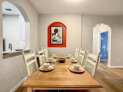 a dining room with a wooden table and chairs at C2785-203-Windsor Hills Resort Free Water Park Themed Rooms in Orlando