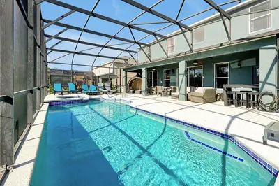 an indoor swimming pool with a glass roof at Waterfront Villa showcasing a theater, games room, and a private pool in Kissimmee