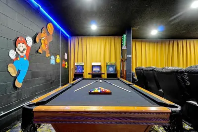 a room with a pool table in a room at Waterfront Villa showcasing a theater, games room, and a private pool in Kissimmee
