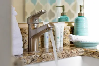 a sink with a faucet in a bathroom at Waterfront Villa showcasing a theater, games room, and a private pool in Kissimmee