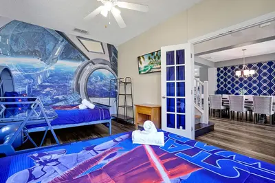 a childrens room with a spaceship themed bedroom at Waterfront Villa showcasing a theater, games room, and a private pool in Kissimmee