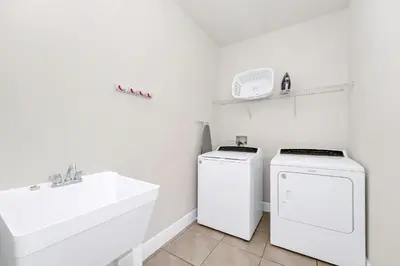 a white bathroom with a sink and a washing machine at Regal Home With Private Pool Near Disney With Waterpark & Resort Access At Encore Resort - 7727Ff in Kissimmee