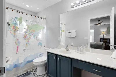 a bathroom with a sink and a toilet and a map on the wall at Six Bedroom Disney Home Lanai Screened Pool & Spa villa in Kissimmee