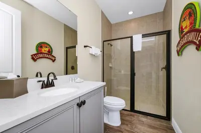 a bathroom with a toilet and a sink and a shower at Magic Vacation Villa Near Disney With Margaritaville Resort & Island H20 Waterpark Access - 2932Or in Orlando