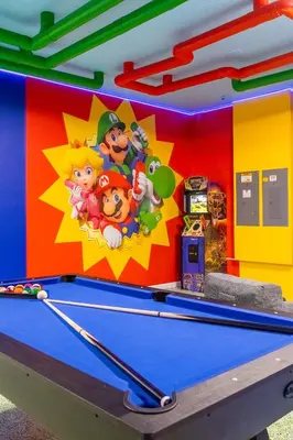 a billiard table in a childrens playroom with toy mario games at Luxury Home - ALL the extras - Sleeps 39 in Kissimmee