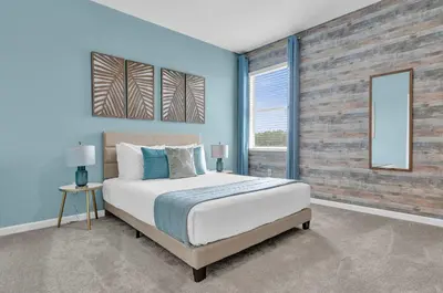 a bedroom with a large bed and a brick wall at Luxury Home - ALL the extras - Sleeps 39 in Kissimmee