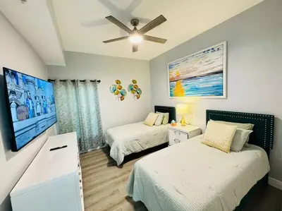 a bedroom with two beds and a ceiling fan at Luxurious & Epic Condo in heart of Orlando in Orlando