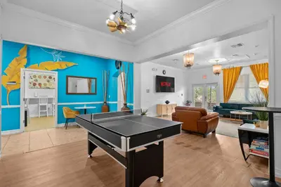 a living room with a ping pong table at Banana Leaf Villa in Orlando