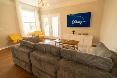 a living room with a couch and a table at Magical Themed 3BR Townhouse Near the Parks in Kissimmee