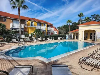 a swimming pool at a resort with lounge chairs at Elegance House in Kissimmee
