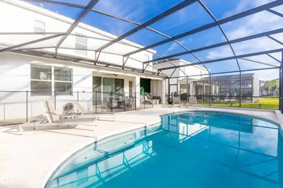 an indoor swimming pool with a glass ceiling at Fantastic 5 BD Pool Near Disney Resort Perks in Kissimmee