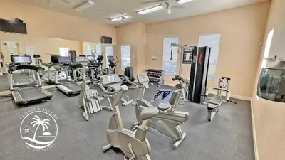 a gym with several treadmills and cardio machines at Standard four beds Villas Seven Dwrafs - Close to Disney in Kissimmee