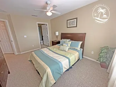 a bedroom with a bed and a ceiling fan at Standard four beds Villas Seven Dwrafs - Close to Disney in Kissimmee