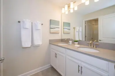 a bathroom with two sinks and a large mirror at 4 BD 3 BA Private Pool Storey Lake 4832 in Kissimmee