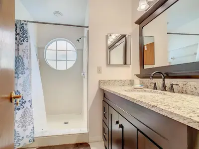 a bathroom with a shower and a sink at Quaint Getaway! 3 Bedroom Condo Near Disney Parks! in Kissimmee