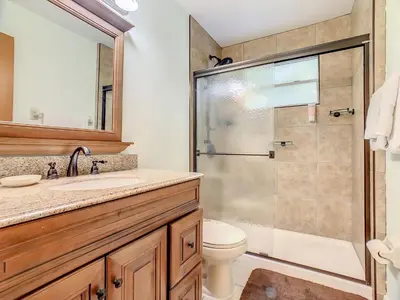 a bathroom with a shower and a toilet and a sink at Quaint Getaway! 3 Bedroom Condo Near Disney Parks! in Kissimmee