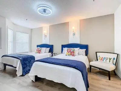 two beds in a room with blue and white at Be Our Guest! 1 Bedroom Condo Near Disney Parks! in Orlando