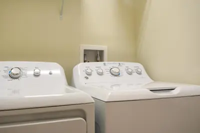 a bathroom with a sink and a washing machine at Enchanted Orlando Getaway, 10 minutes from Disney in Kissimmee