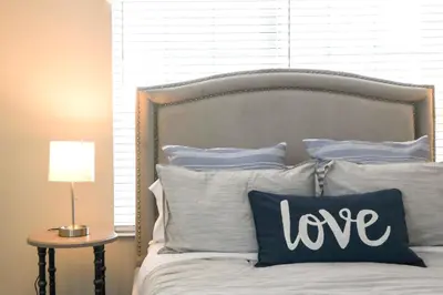 a bed with a pillow with the word love on it at Enchanted Orlando Getaway, 10 minutes from Disney in Kissimmee