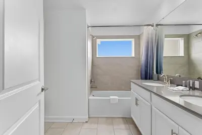 a white bathroom with two sinks and a bath tub at Disney Getaway Prime Location Themed Rooms in Kissimmee