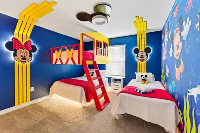 a childs bedroom with blue and yellow walls at Disney Getaway Prime Location Themed Rooms in Kissimmee