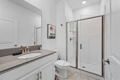 a white bathroom with a sink and a toilet at Disney Getaway Prime Location Themed Rooms in Kissimmee