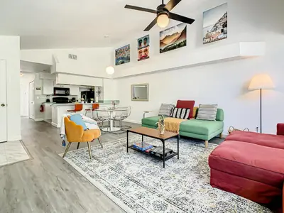 a living room with a couch and a table at La Casa Mediterranean! 3 Bedroom Condo Near Disney! in Kissimmee
