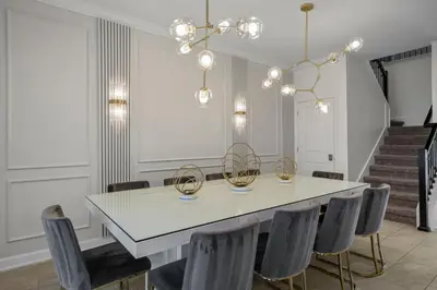 a dining room with a white table and chairs at 2912 Storey Lake new game room 24 guests poolspa in Kissimmee