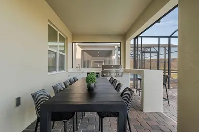 a dining room with a table and chairs at 2912 Storey Lake new game room 24 guests poolspa in Kissimmee