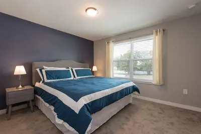 a bedroom with a large bed and a window at Family and Fun Home with Splash Pool at Le Reve 08 in Kissimmee