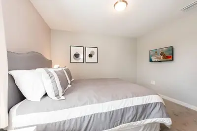 a white bedroom with a bed with two pillows at Family and Fun Home with Splash Pool at Le Reve 08 in Kissimmee