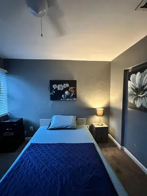 a bedroom with a blue bed with a blue blanket at Downtown Private Deluxe Room in Orlando