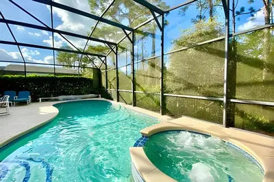 an indoor swimming pool in a glass house at 6Q/5.5B Luxo Piscina Priv. Disney in Kissimmee