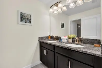 a bathroom with two sinks and a mirror at 4804Crusoe townhouse in Kissimmee