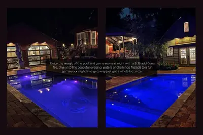 a swimming pool at night with blue lights at Mills Cottage in Orlando