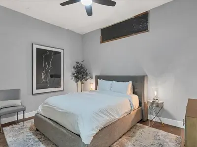 a bedroom with a bed and a ceiling fan at Luxury 1260sq ft 2 Bd 2BTH in DT in Orlando