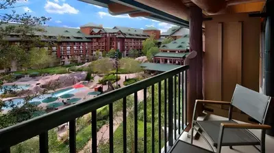 a balcony with a chair and a view of a resort at Disney's Wilderness Lodge in Orlando