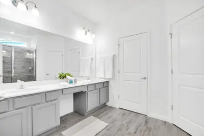 a white bathroom with two sinks and a shower at Dynamic 15 Bed With Character Bedrooms Pool, Spa! villa in Kissimmee