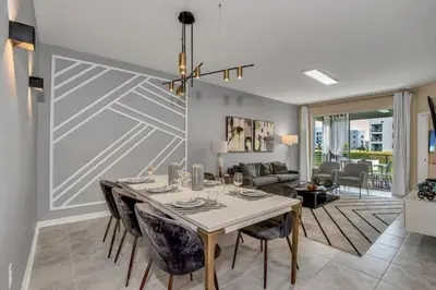 a dining room with a table and chairs and a living room at 3180 Para unit 101 townhouse in Kissimmee