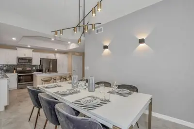 a dining room with a white table and chairs at 3180 Para unit 101 townhouse in Kissimmee