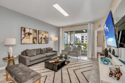 a living room with a couch and a tv at 3180 Para unit 101 townhouse in Kissimmee
