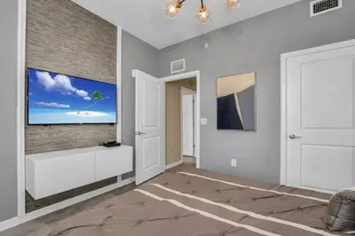 a living room with a flat screen tv on a wall at 3180 Para unit 101 townhouse in Kissimmee
