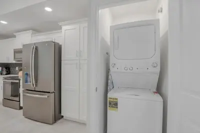 a kitchen with a refrigerator and a microwave at 3180 Para unit 101 townhouse in Kissimmee