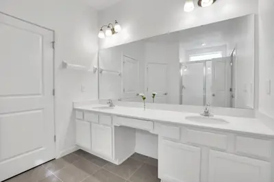a white bathroom with two sinks and a large mirror at Amazing 15 Bedroom house at Veranda Palms 2395RAMA villa in Kissimmee