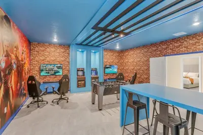 a room with a blue table and chairs at 4552Target home in Kissimmee