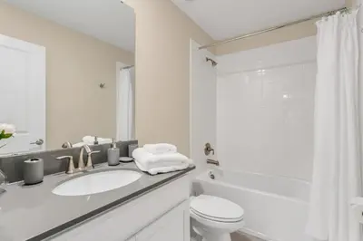 a white bathroom with a sink and a toilet at 4552Target home in Kissimmee