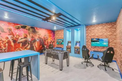 a gaming room with a mural of the avengers at 4552Target home in Kissimmee
