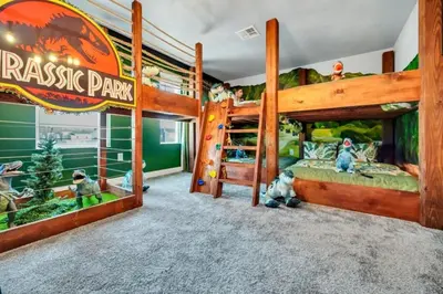 a bedroom with two bunk beds and a dinosaur theme at 2900Penolpe home in Kissimmee